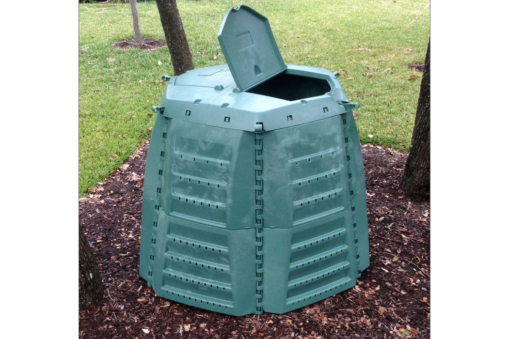 Green compost bin with open lid on a grassy background